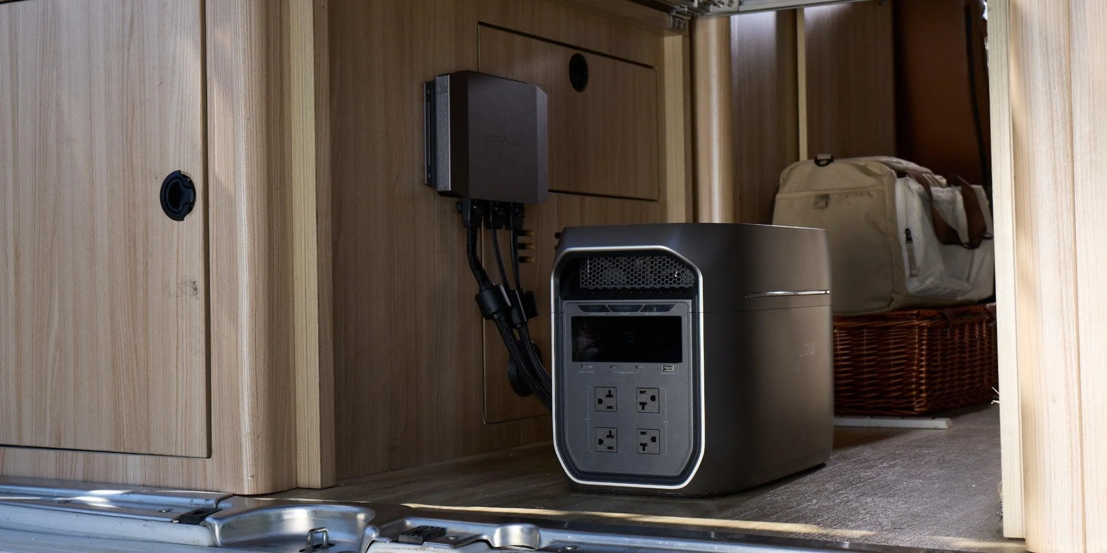 EcoFlow DELTA 3 Max Plus portable power station connected to a wall-mounted power hub inside an RV, providing reliable off-grid power for campervan life
