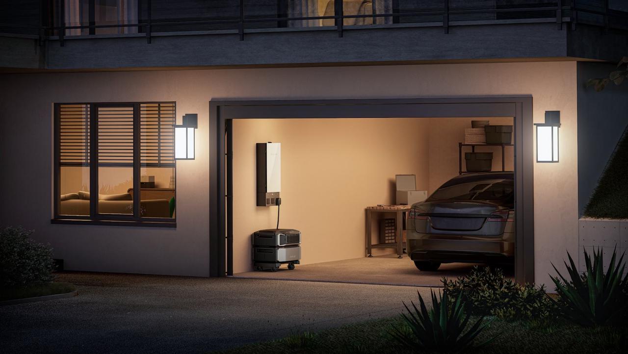 Twilight garage scene, EcoFlow DELTA Pro Ultra home energy storage unit hardwired to transfer panel beside electric vehicle
