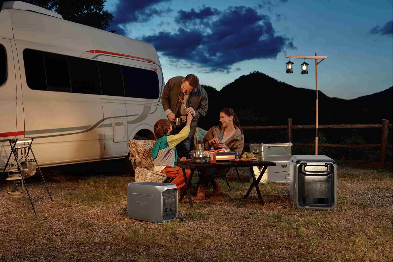 Nighttime outdoor barbecue beside camper van, EcoFlow DELTA 3 Max portable power station supplying electricity for camping gear