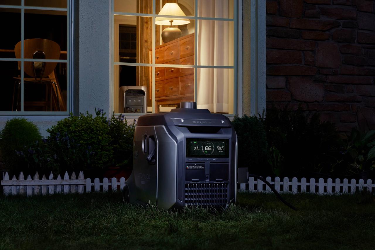 Large EcoFlow whole-home backup power generator placed outside residential house at night, heavy-duty portable battery supplies full-house appliances during thunderstorm power outages