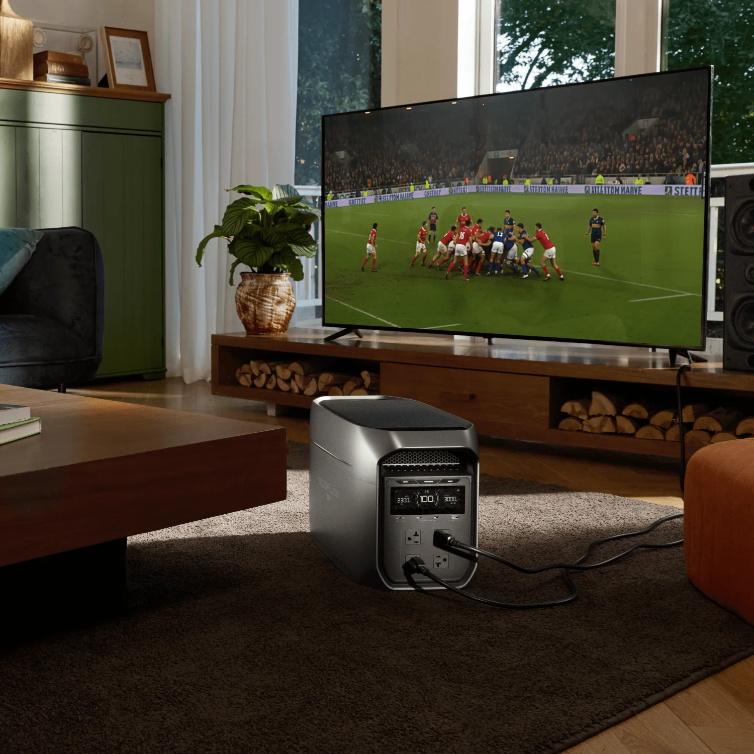 EcoFlow DELTA 3 Max wheeled portable power station powers smart TV during football match at home living room, large-capacity backup battery ensures entertainment runs smoothly amid unexpected household power outages