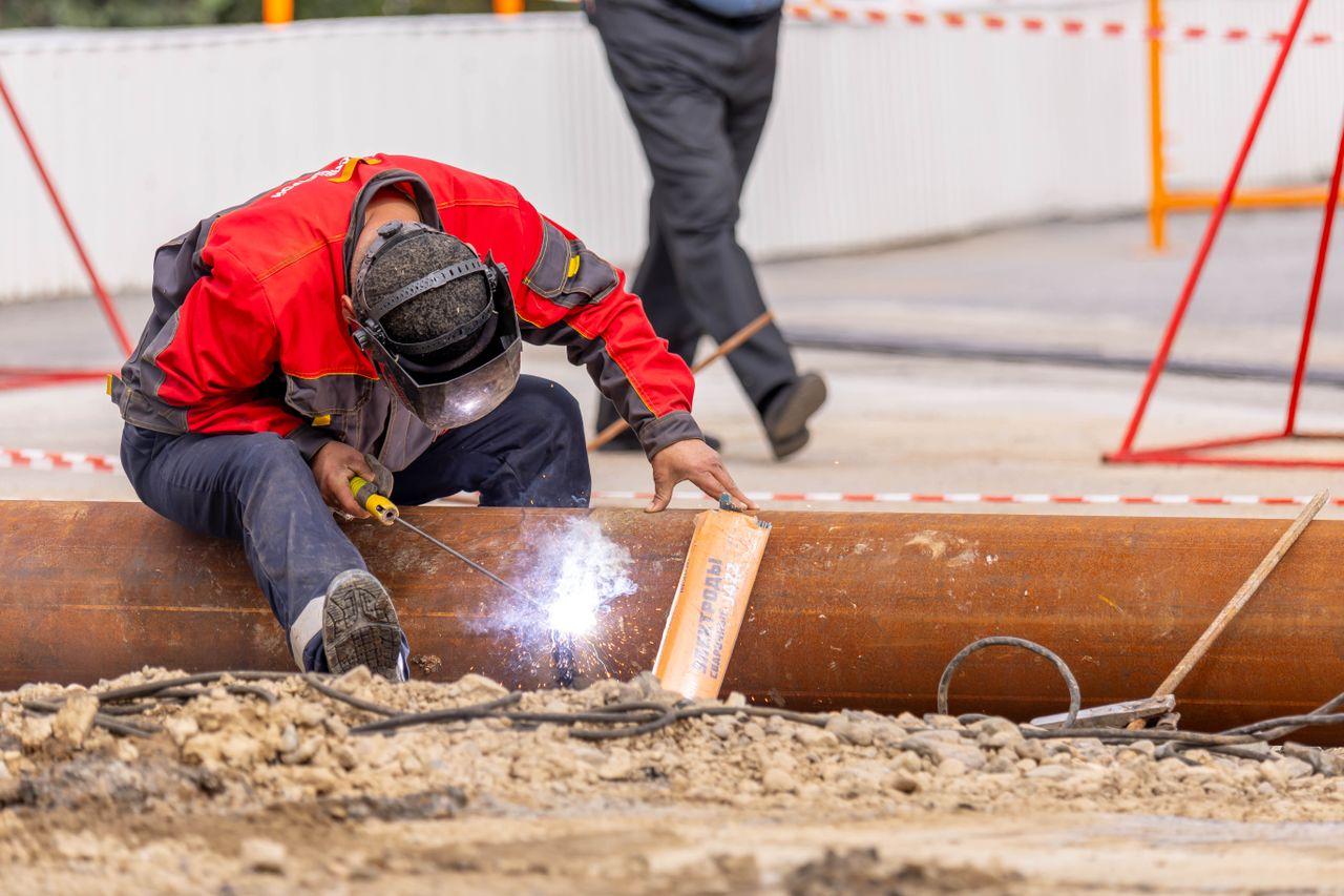 Construction site worker welding a pipe