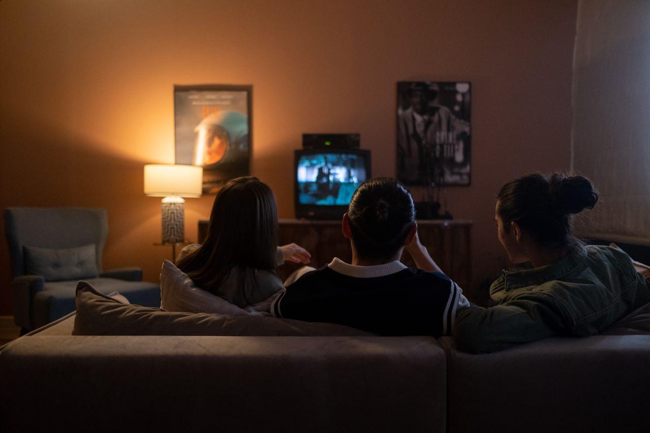  Three people enjoying a relaxed movie night